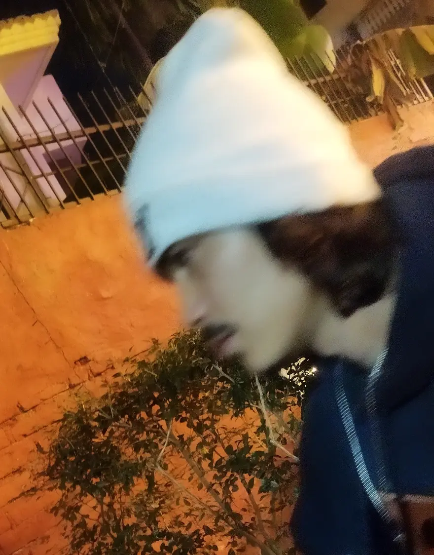 Colson — night photo in a beanie and hoodie